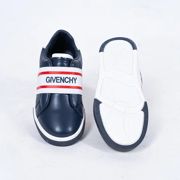 Close-up of boys' and girls' navy slip-on sneakers with white sole and red accent band, Jaipur

