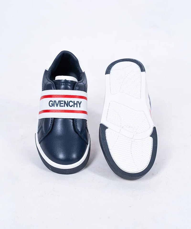 Close-up of boys' and girls' navy slip-on sneakers with white sole and red accent band, Jaipur

