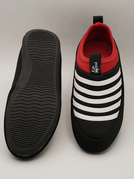 Close-up of kids' black and white striped sports sneakers with red detail, Jaipur.
