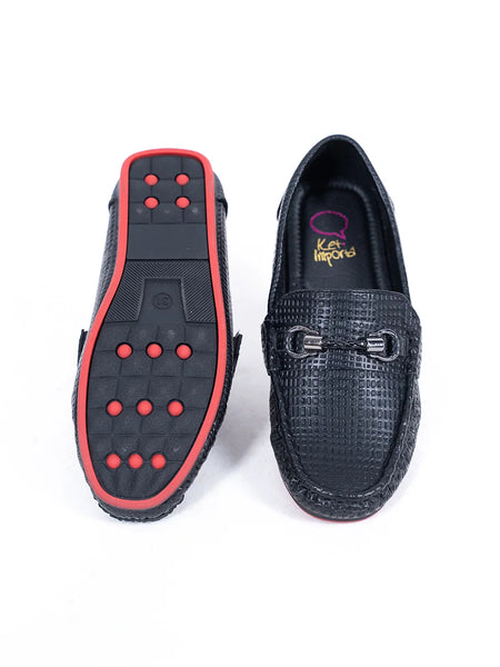 Close-up of kids' black moccasins with cushioned insole and signature buckle, Jaipur