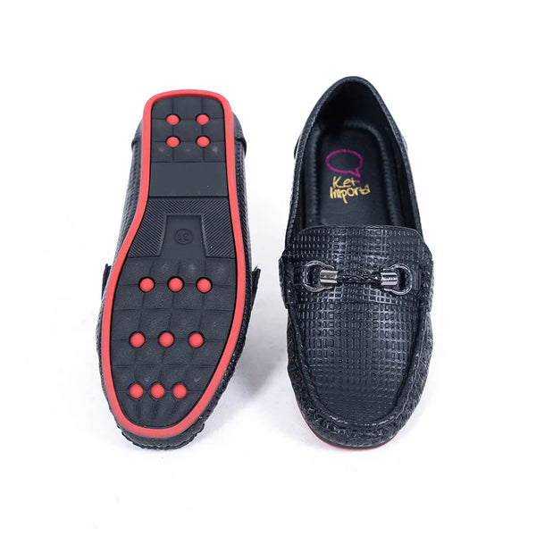 Close-up of kids' black moccasins with cushioned insole and signature buckle, Jaipur