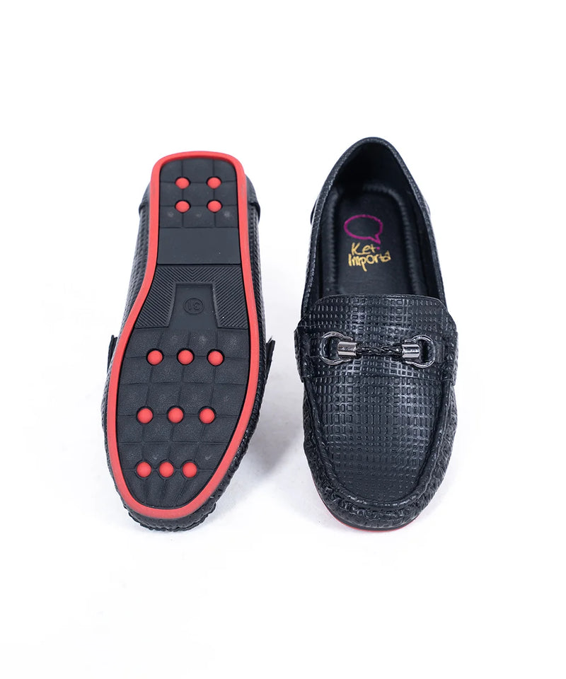 Close-up of kids' black moccasins with cushioned insole and signature buckle, Jaipur