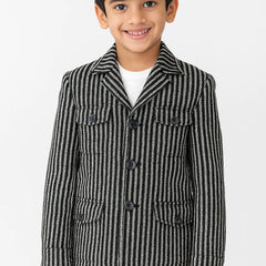 Child wearing a black and white striped coat on a white background