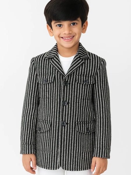 Child wearing a black and white striped coat on a white background