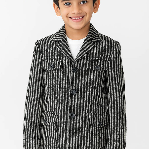 Child wearing a black and white striped coat on a white background