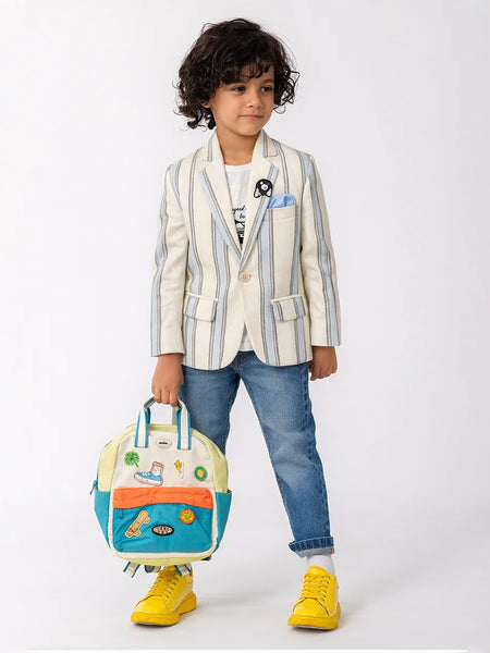 Child wearing a striped blazer with a colorful backpack on a white background