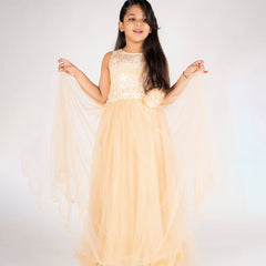 Young girl in a beige evening gown with lace details on a white background