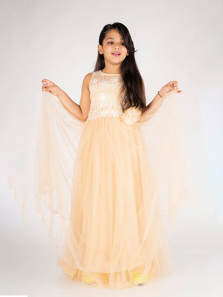 Young girl in a beige evening gown with lace details on a white background