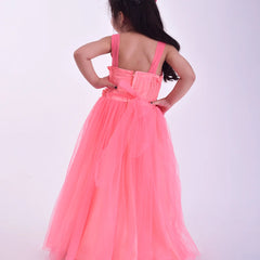 Young girl wearing a pink dress with a bow on a white background