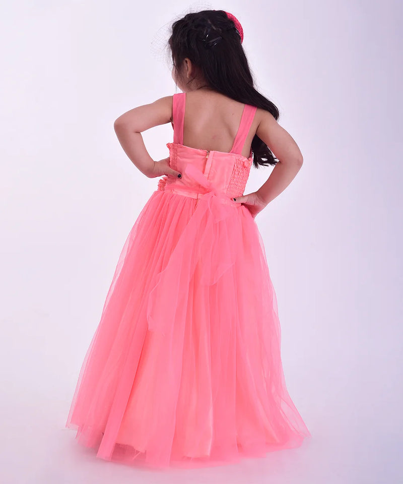 Young girl wearing a pink dress with a bow on a white background