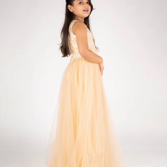 Young girl in a peach dress with floral top on a white background
