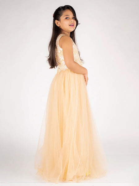 Young girl in a peach dress with floral top on a white background