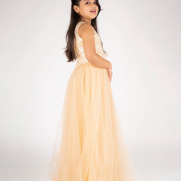 Young girl in a peach dress with floral top on a white background