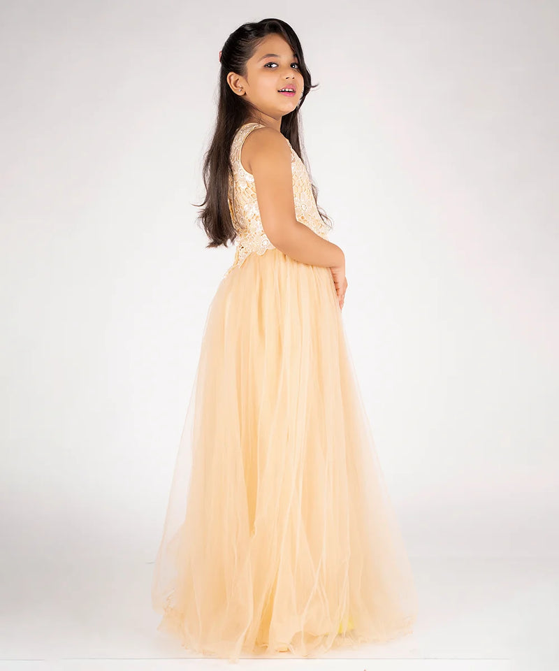 Young girl in a peach dress with floral top on a white background