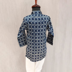 Blue patterned shirt on a mannequin against a beige background