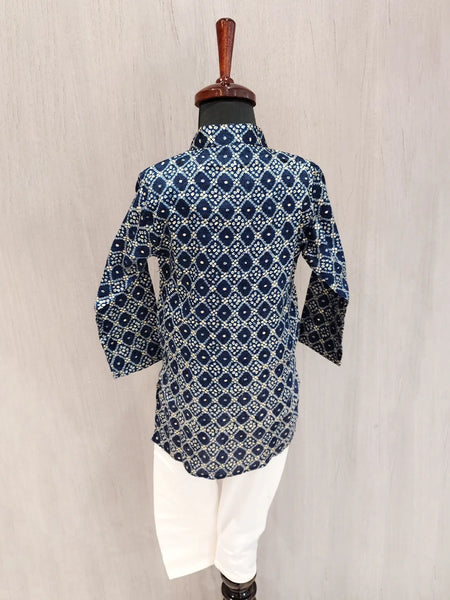 Blue patterned shirt on a mannequin against a beige background