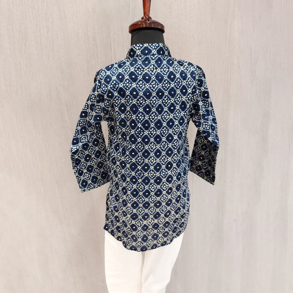 Blue patterned shirt on a mannequin against a beige background