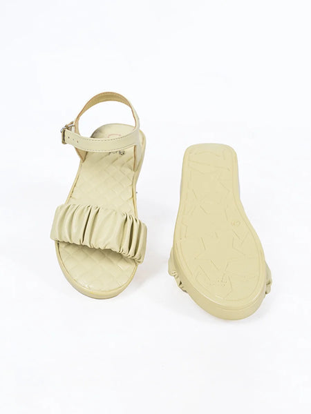 Close-up of trendy girls' beige flat sandals with quilted insole and adjustable strap, Jaipur