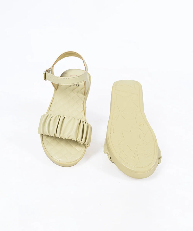 Close-up of trendy girls' beige flat sandals with quilted insole and adjustable strap, Jaipur