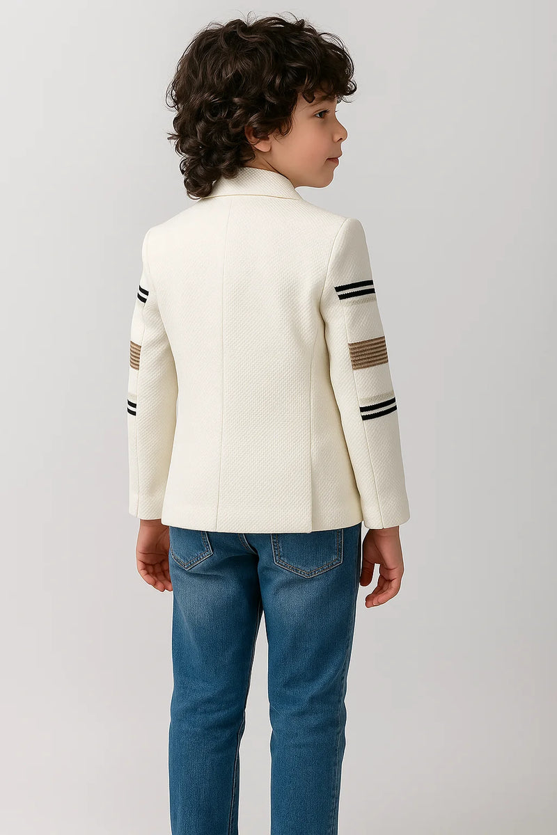 Child wearing a white jacket with black and brown stripes on a light gray background