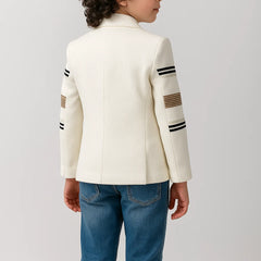 Child wearing a white jacket with black and brown stripes on a light gray background