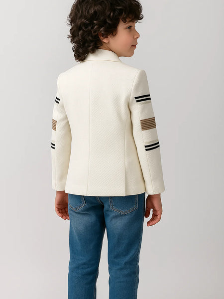 Child wearing a white jacket with black and brown stripes on a light gray background