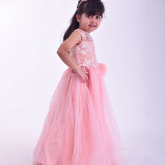 Young girl in a pink dress with lace details on a white background