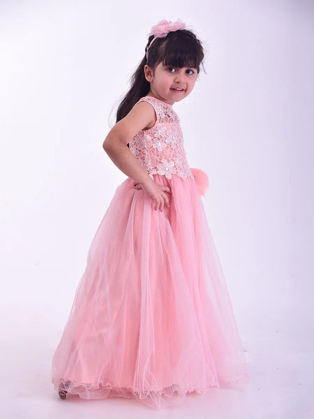 Young girl in a pink dress with lace details on a white background