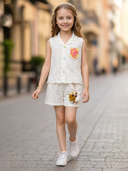 Young girl in a white outfit with floral details walking on a street.