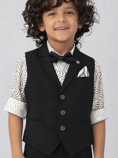 Child wearing a black vest over a patterned shirt on a plain background