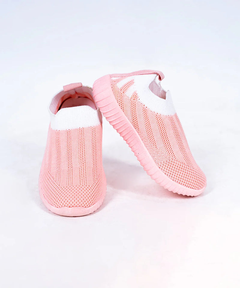 Close-up of trendy girls' pastel pink slip-on shoes with mesh upper, Jaipur