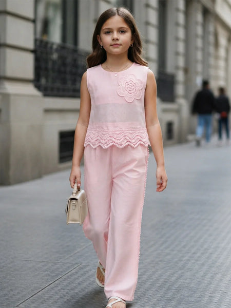 Young girl in a pink outfit walking on a city street.