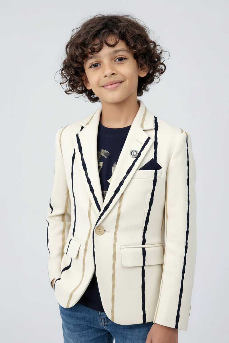 Child wearing a white blazer with black trim on a light gray background