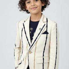 Child wearing a white blazer with black trim on a light gray background