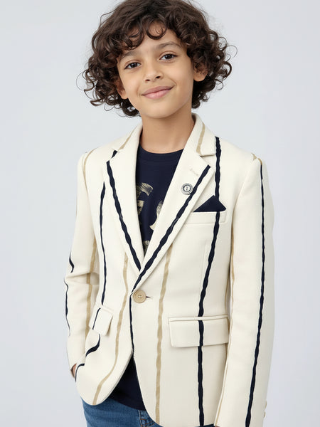 Child wearing a white blazer with black trim on a light gray background