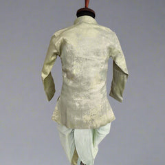 A green dhoti set for infants displayed on a mannequin, with the back view showcasing the shimmering fabric.