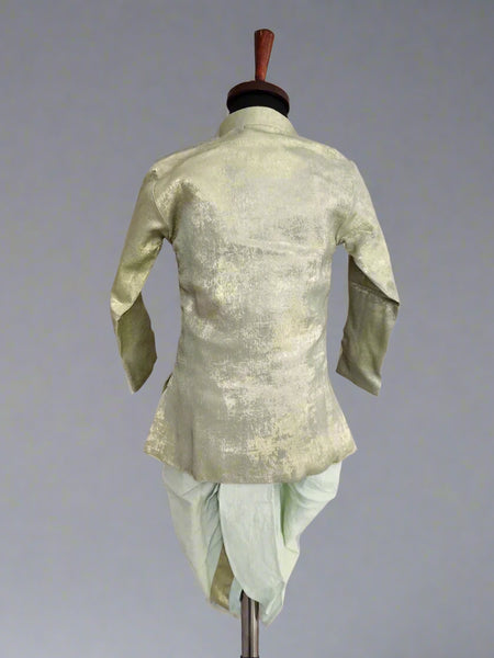 A green dhoti set for infants displayed on a mannequin, with the back view showcasing the shimmering fabric.