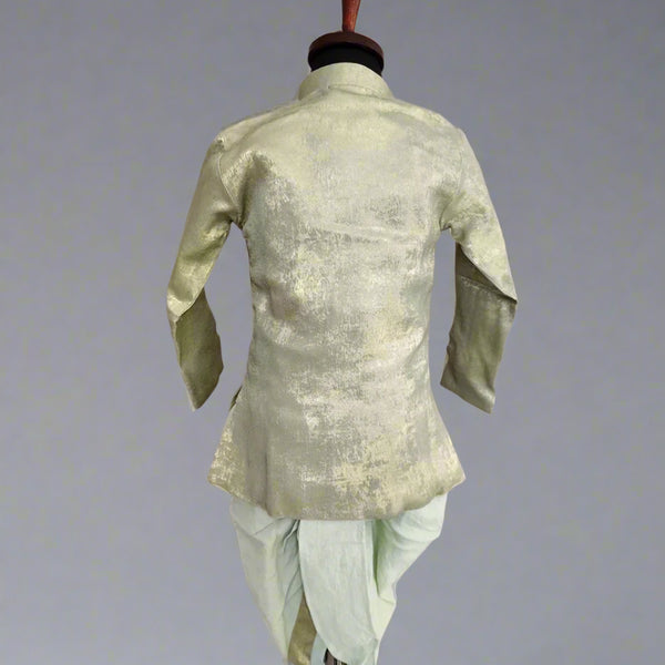 A green dhoti set for infants displayed on a mannequin, with the back view showcasing the shimmering fabric.