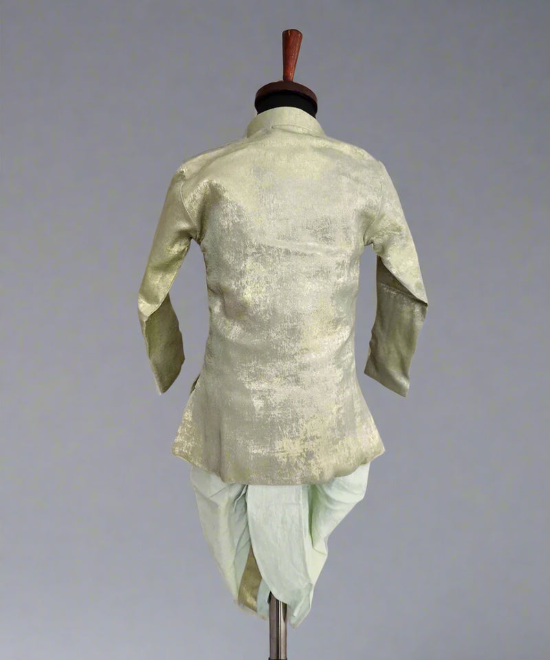 A green dhoti set for infants displayed on a mannequin, with the back view showcasing the shimmering fabric.