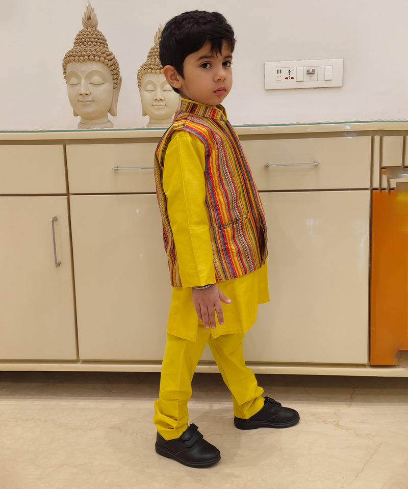 This is side look of yellow color plain kurta pajama with multi color stripe jacket