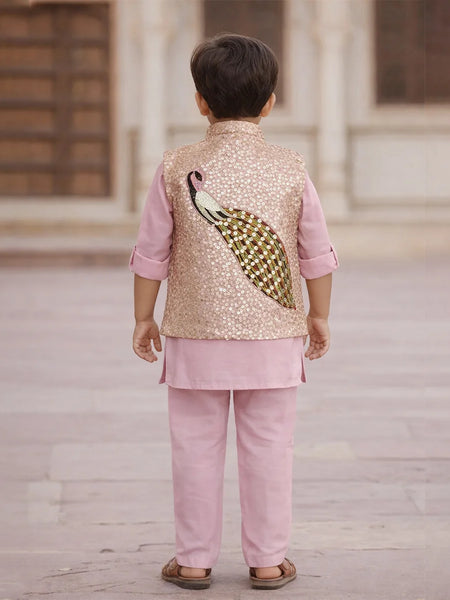 Child wearing a traditional outfit with a sequined vest featuring a peacock design.