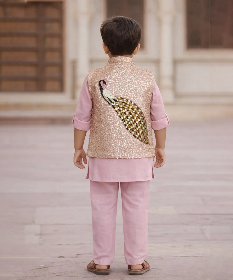 Child wearing a traditional outfit with a sequined vest featuring a peacock design.