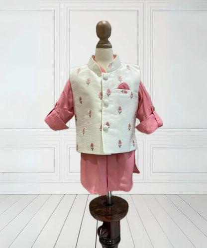 It consists of a pink Colored  kurta, a pyjama, a cream colored  floral embroidered waistcoat and a pocket square. Buy kid's kurtas online for boys.