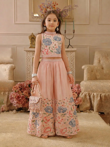 Young girl in a floral outfit standing in an elegant room with floral decorations.