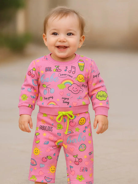 A cute infant baby wearing multi print co-ord and enjoy the games.