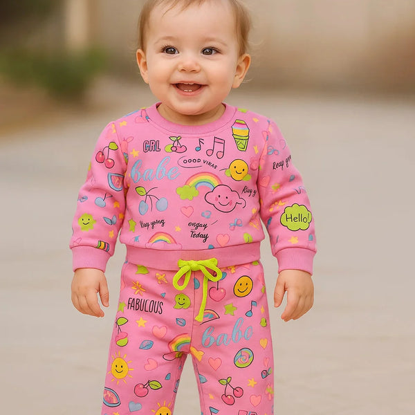 A cute infant baby wearing multi print co-ord and enjoy the games.