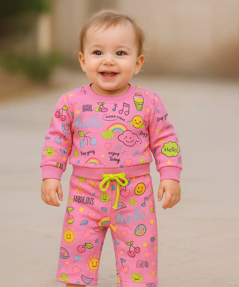 A cute infant baby wearing multi print co-ord and enjoy the games.