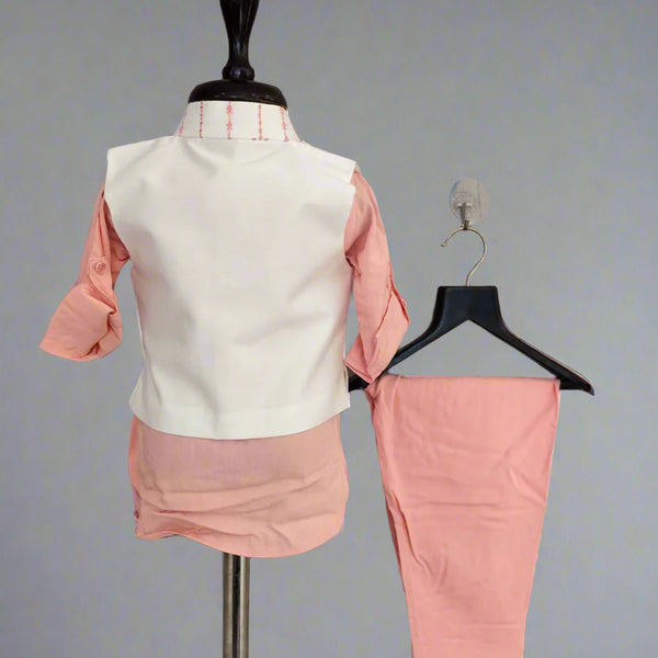 Pink outfit with a white vest on a mannequin against a gray background