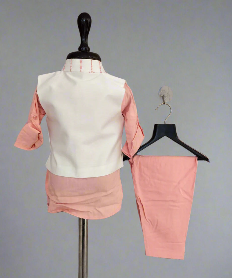 Pink outfit with a white vest on a mannequin against a gray background