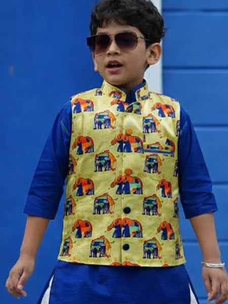 Child wearing a colorful vest over a blue shirt against a blue background